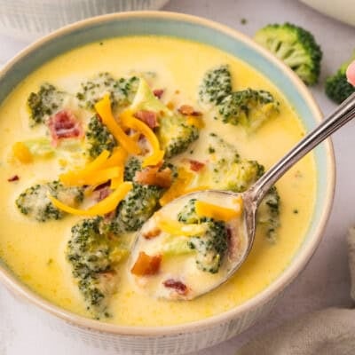 Broccoli cauliflower soup in bowl with spoon.