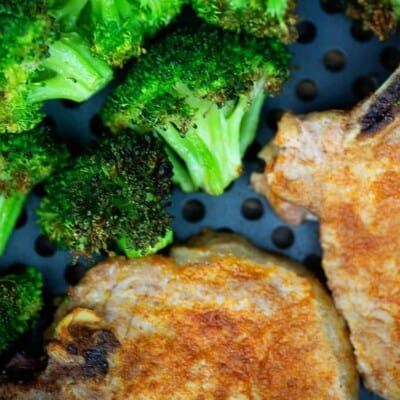 A plate of food with broccoli, with Pork chop