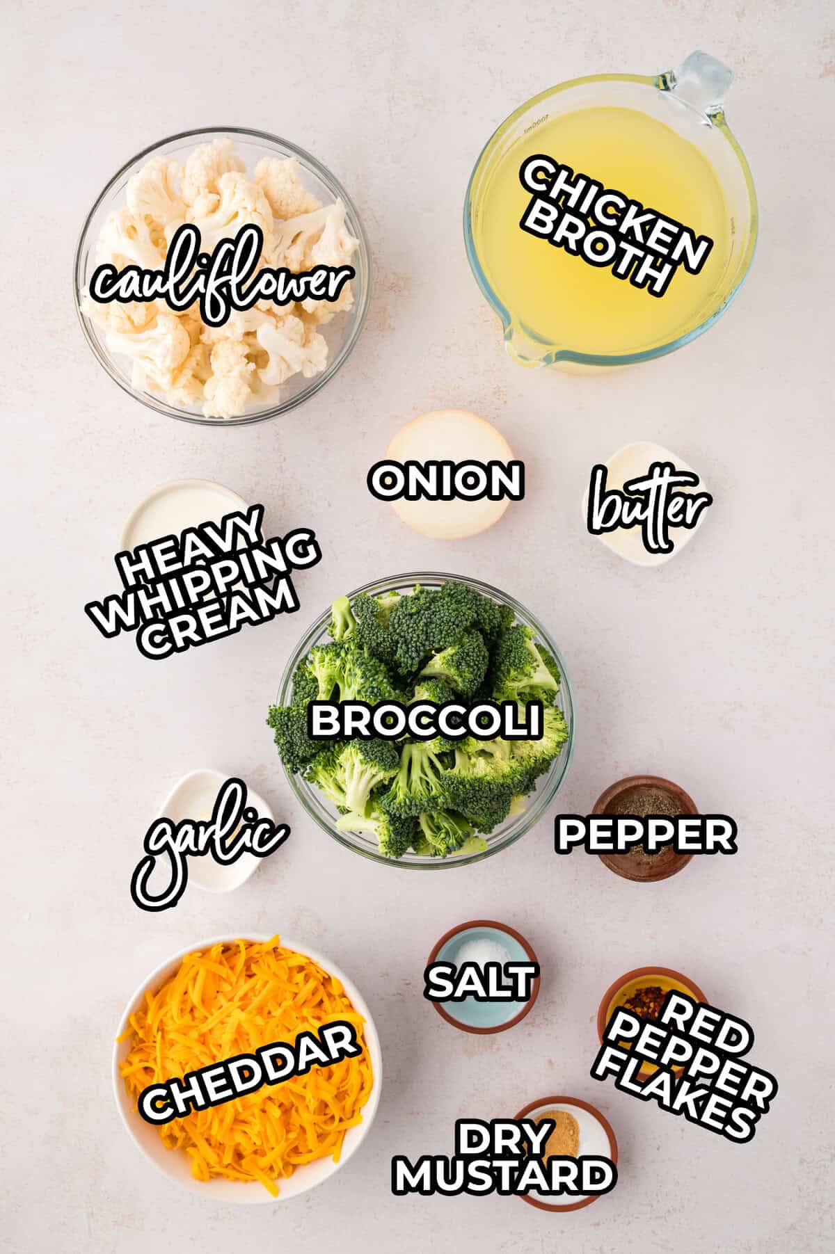 Ingredients for soup laid out in dishes on counter.