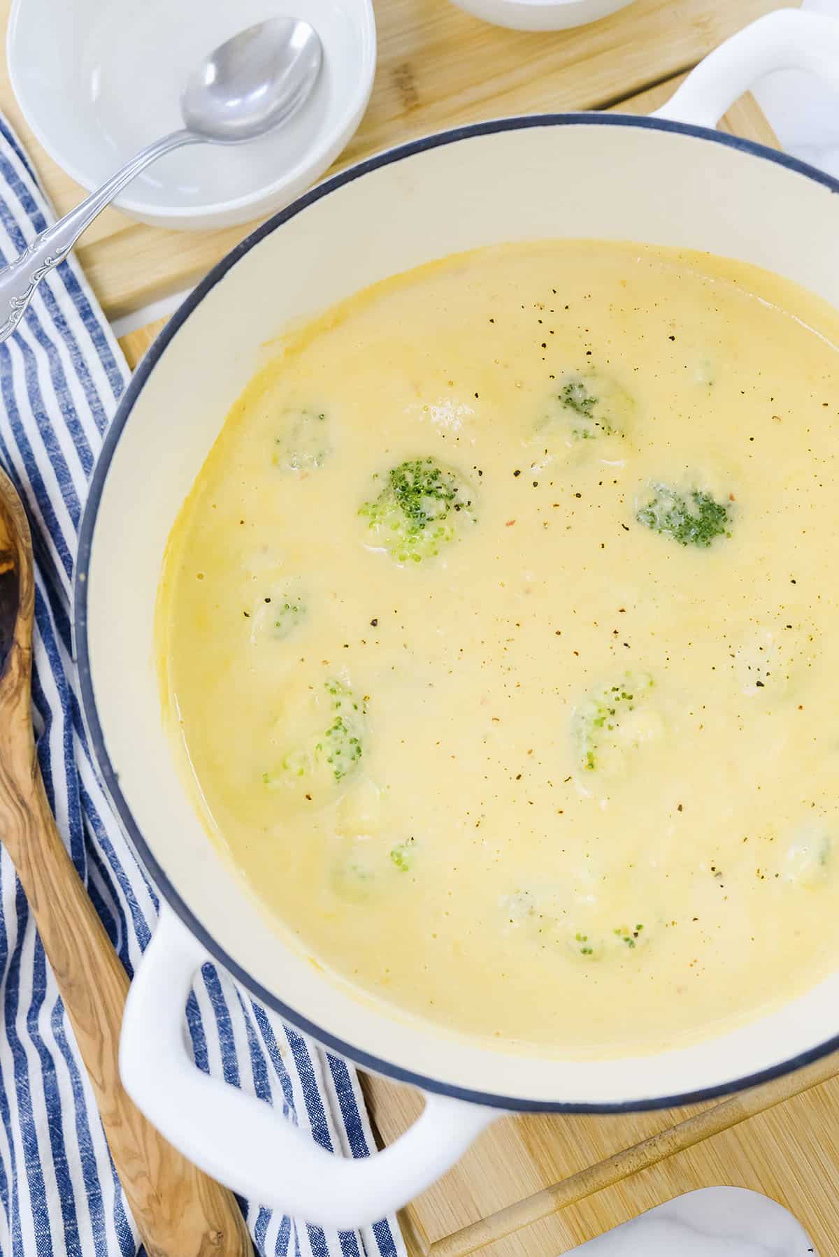 Overhead view of broccoli and cauliflower soup in white pot.