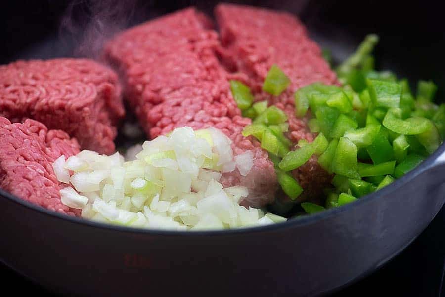 raw ingredients for keto chili in a white skillet