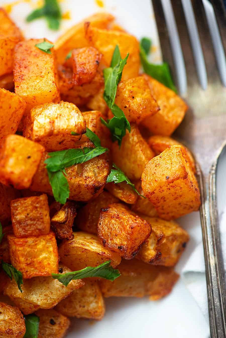 close up view of rasted turnips and a fork