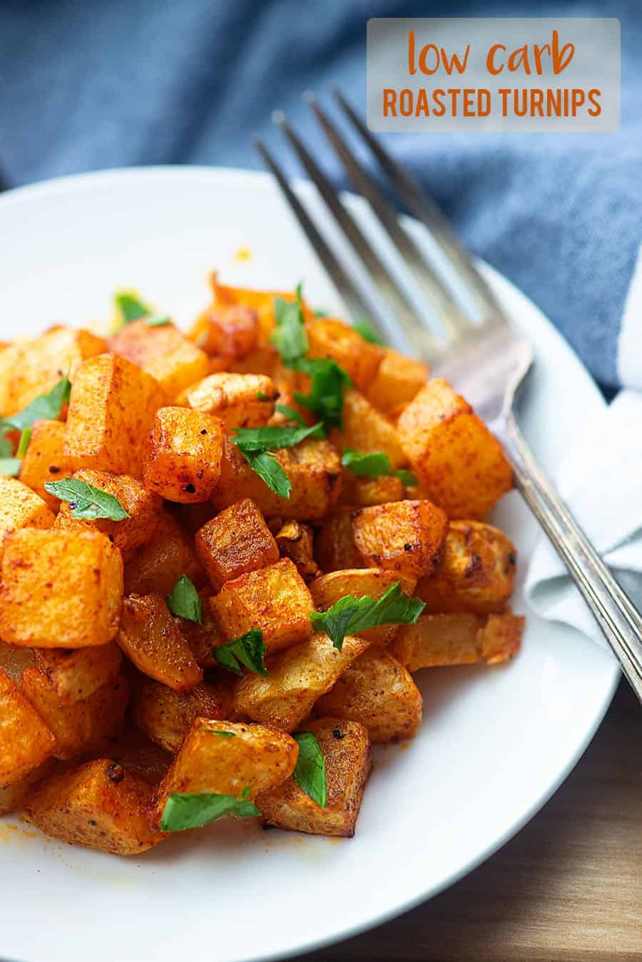 roasted turnips on a white plate with a fork