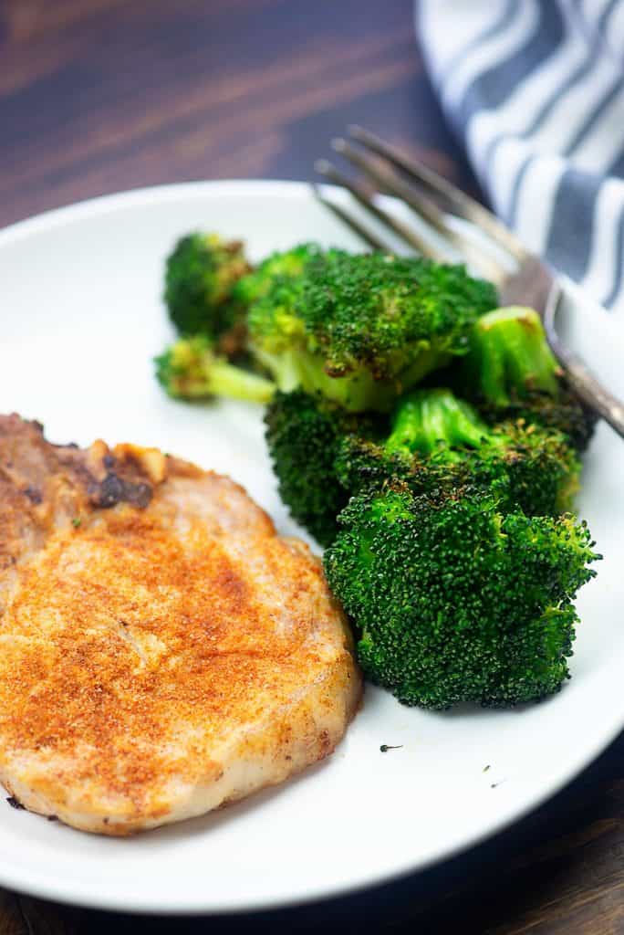Air Fryer Pork Chops and Broccoli! Perfectly juicy pork chops and roasted broccoli all at once! #airfryer #porkchops #broccoli #easy