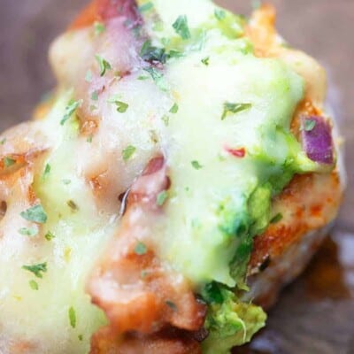 A close up of a plate of food with broccoli, with Chicken and Guacamole