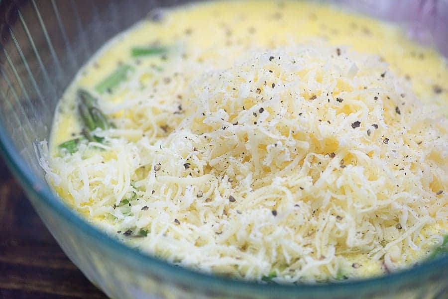 cheese and raw eggs in a glass bowl