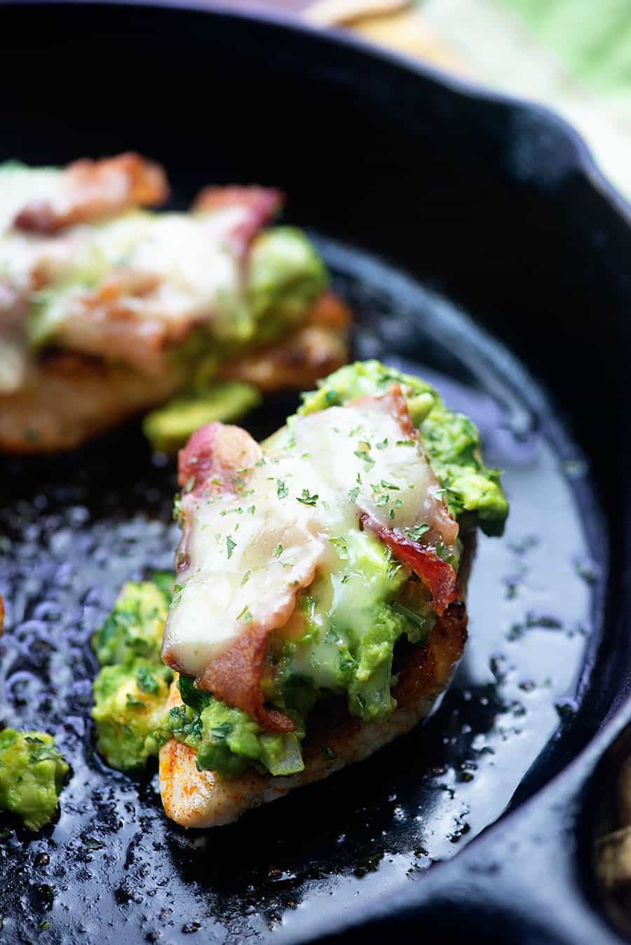 chicken frying in a cast iron skillet