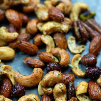 Various roasted nuts on a baking sheet.