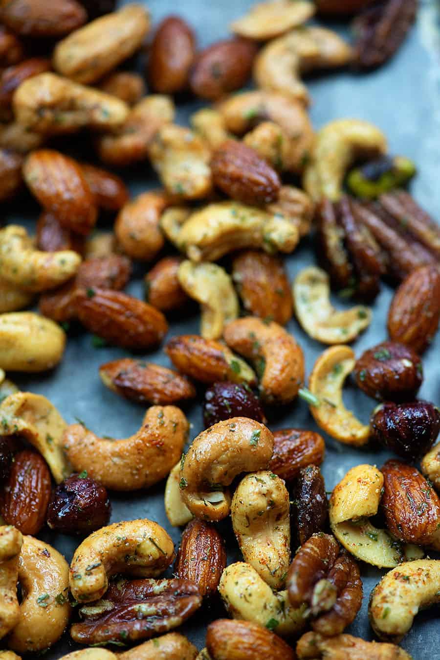 Various roasted nuts on a baking sheet.