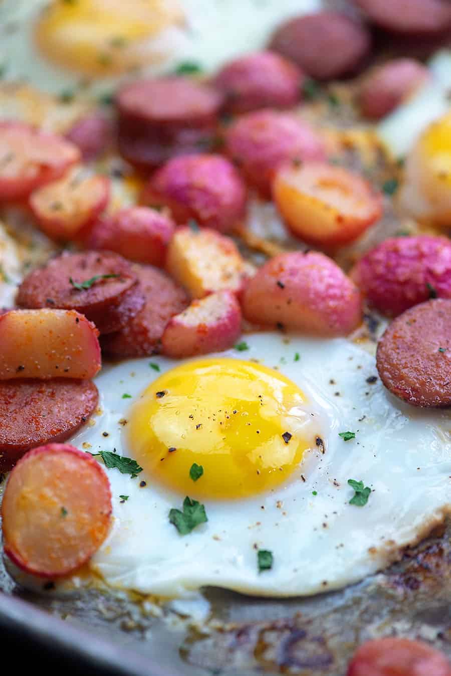 cooked egg and radishes on a baking sheet