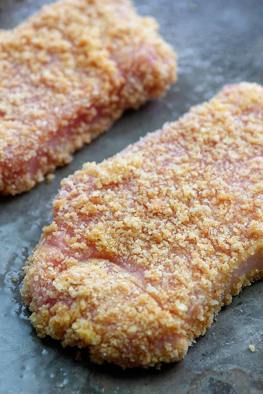 Low carb breaded pork chops on baking sheet