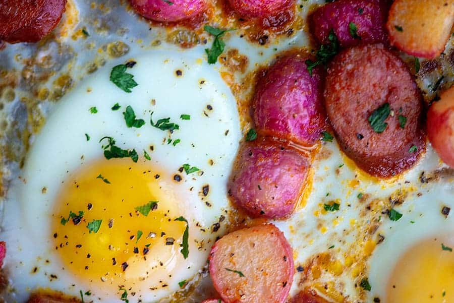seasoned radishes and eggs on a cookie sheet