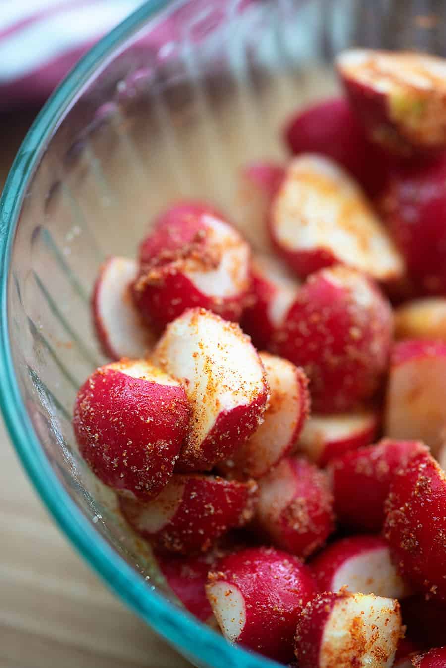 seasoned radishes in glass bowl