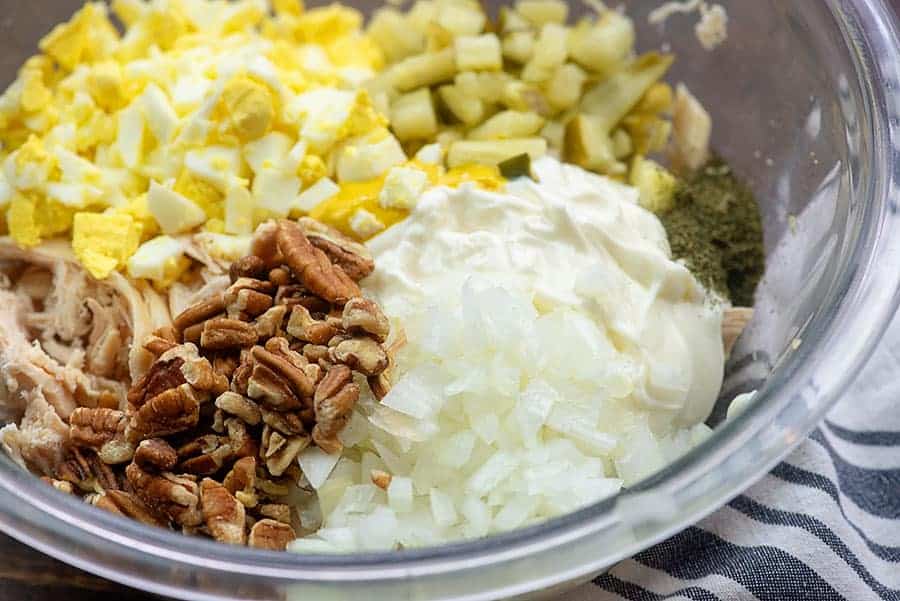 chicken salad ingredients in glass bowl