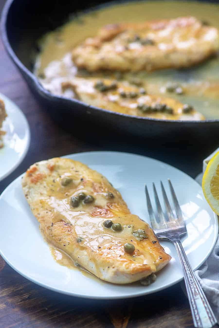 lemon caper chicken on white plate