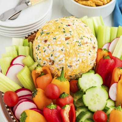 Cheese ball on platter surrounded by low carb vegetables.