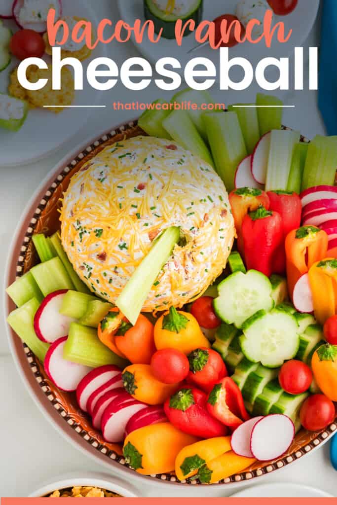 Cheese ball on platter with vegetables and text for Pinterest.