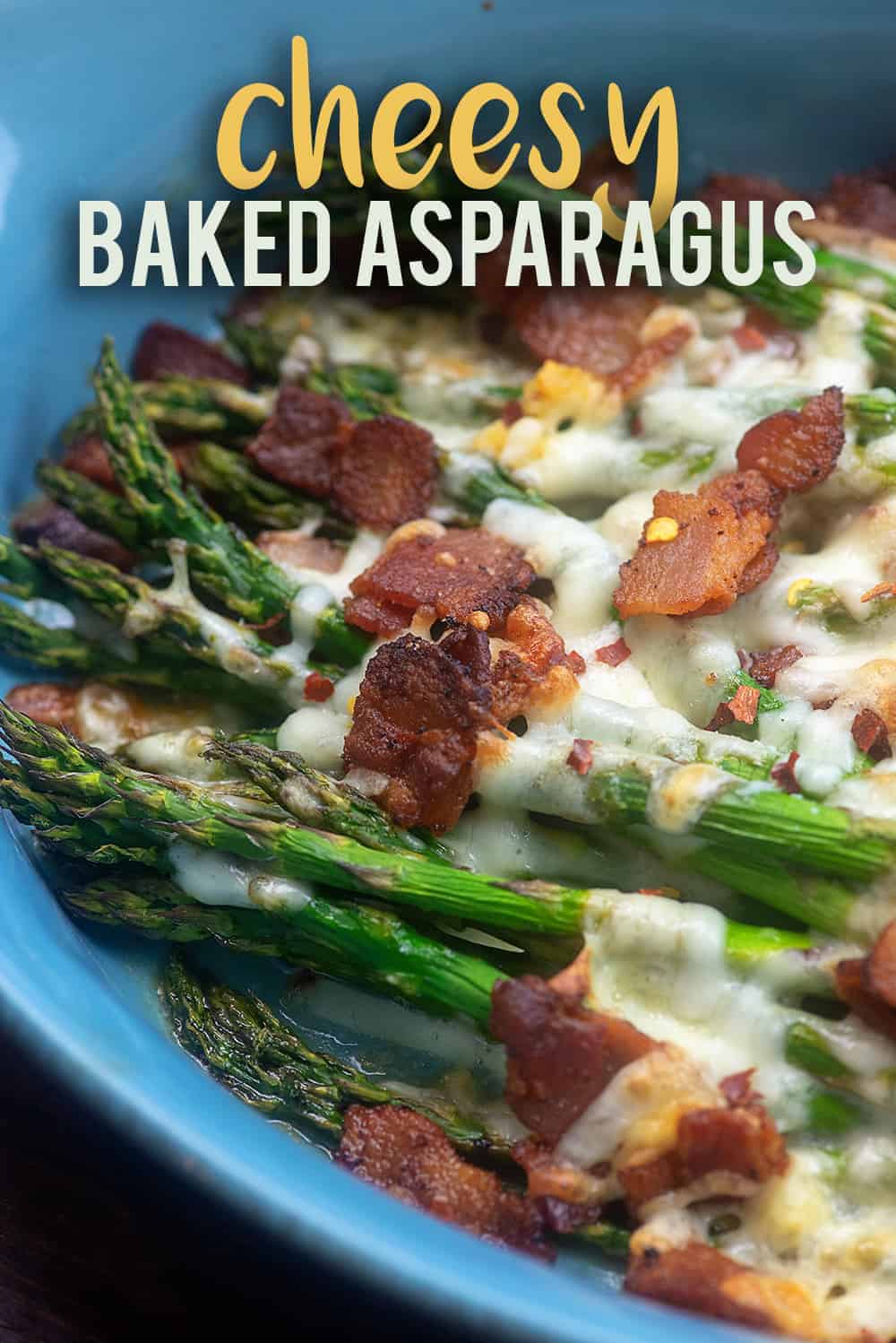 cheesy baked asparagus in blue dish.