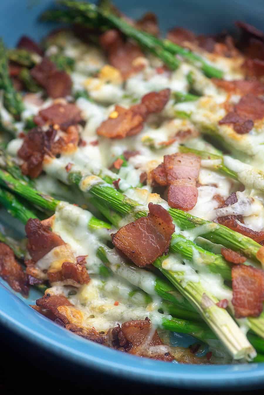 asparagus topped with cheese and bacon.