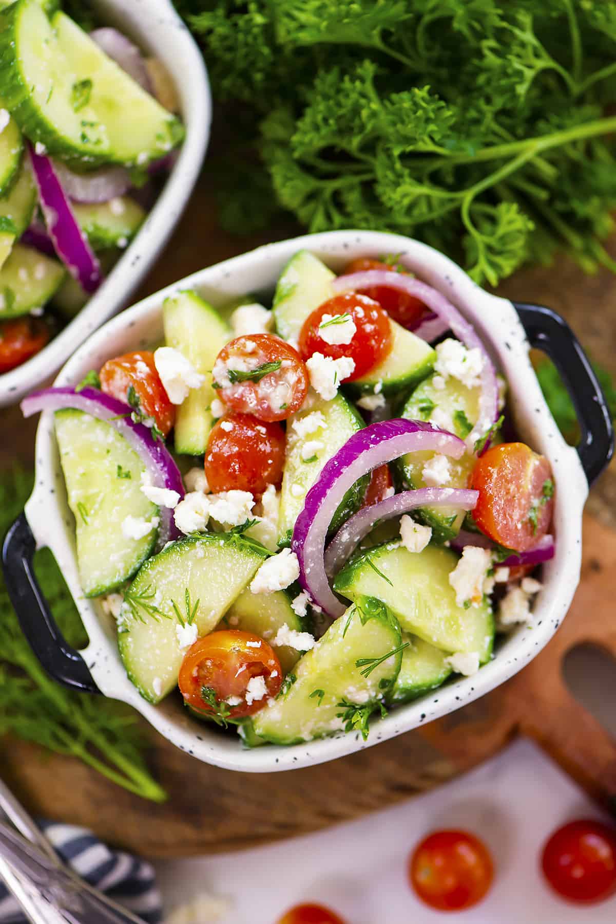 Serving dish filled with cucumber tomato feta salad recipe.