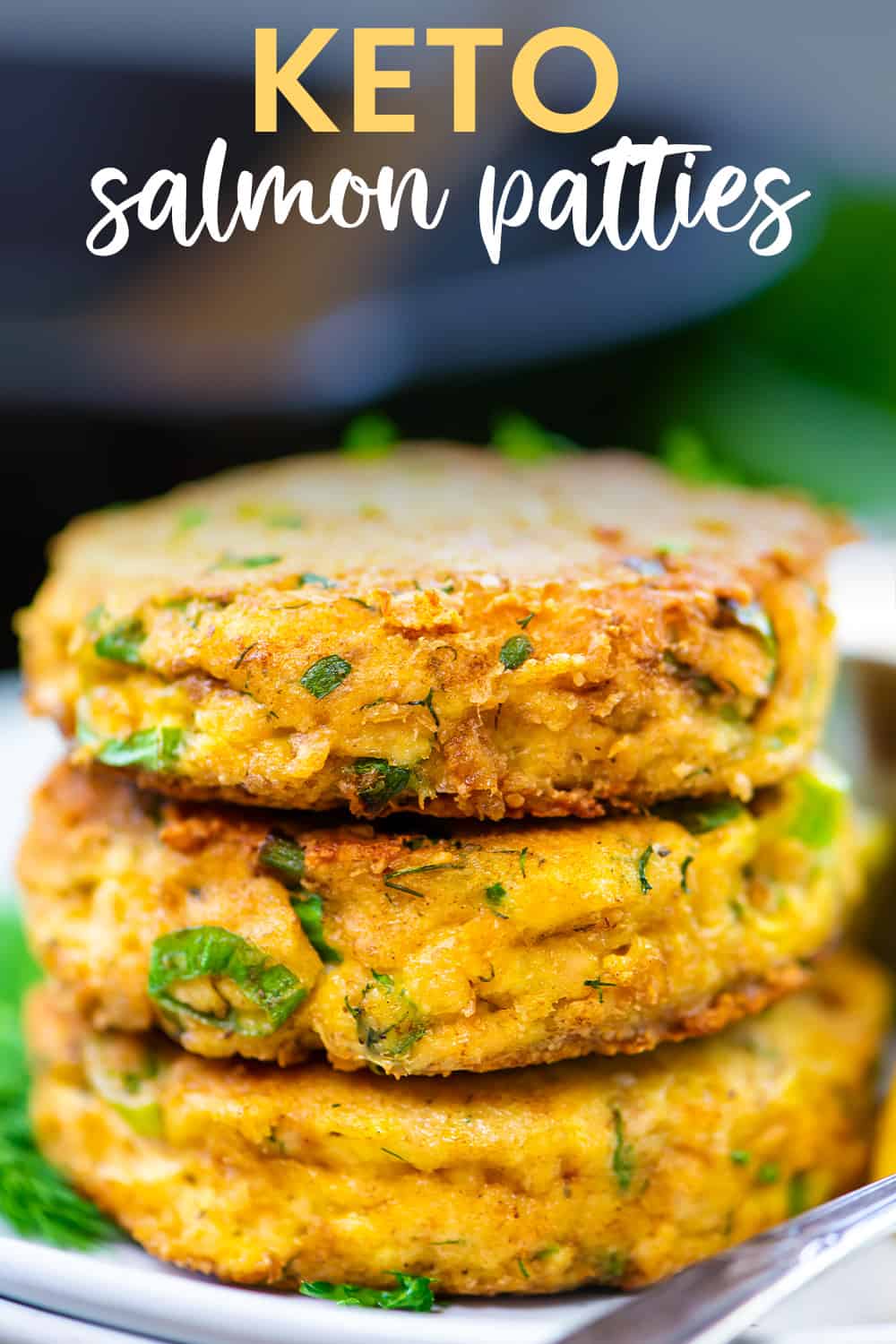 Salmon patties in a stack on a small plate.