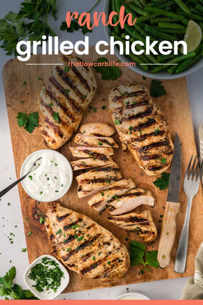 Grilled chicken on wooden cutting board.