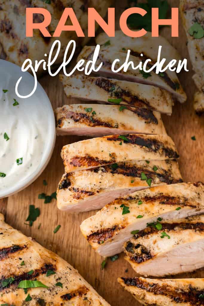 Sliced grilled chicken on cutting board.