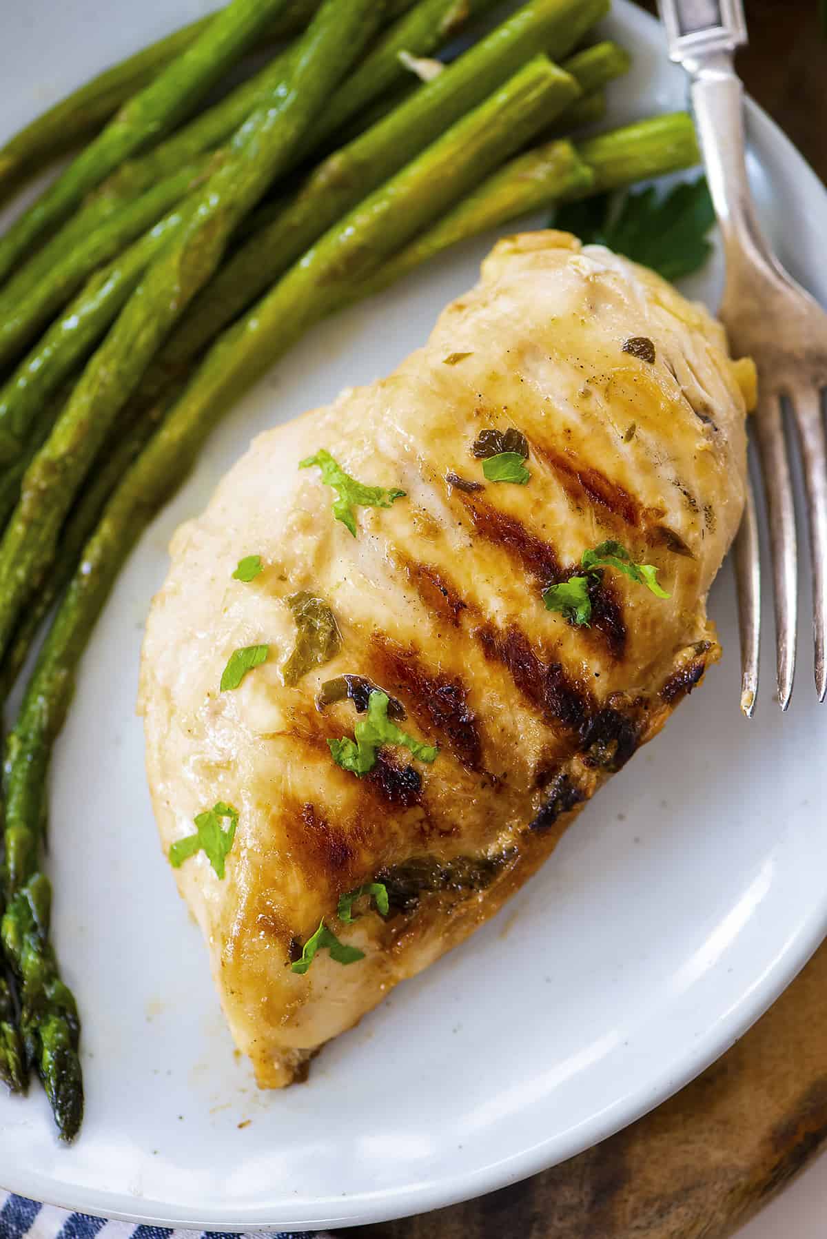 Ranch grilled chicken on plate with asparagus.