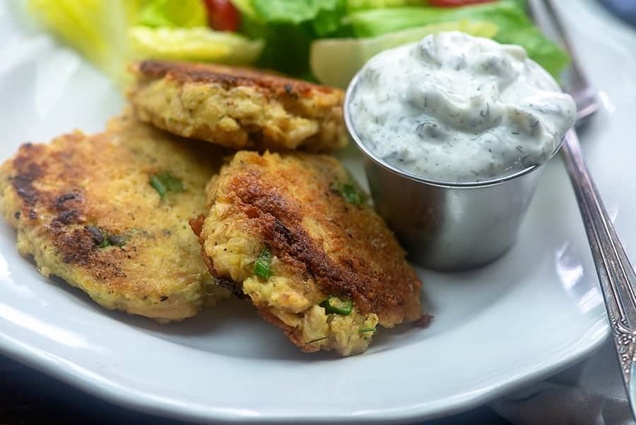 homemade salmon patties on white plate.