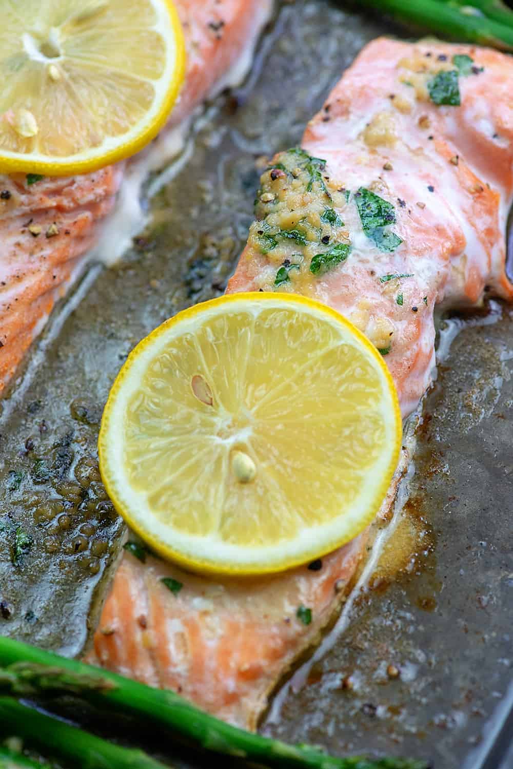 A close up of salmon on a baking sheet.
