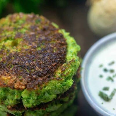 A close up of food, with Broccoli and Fritter