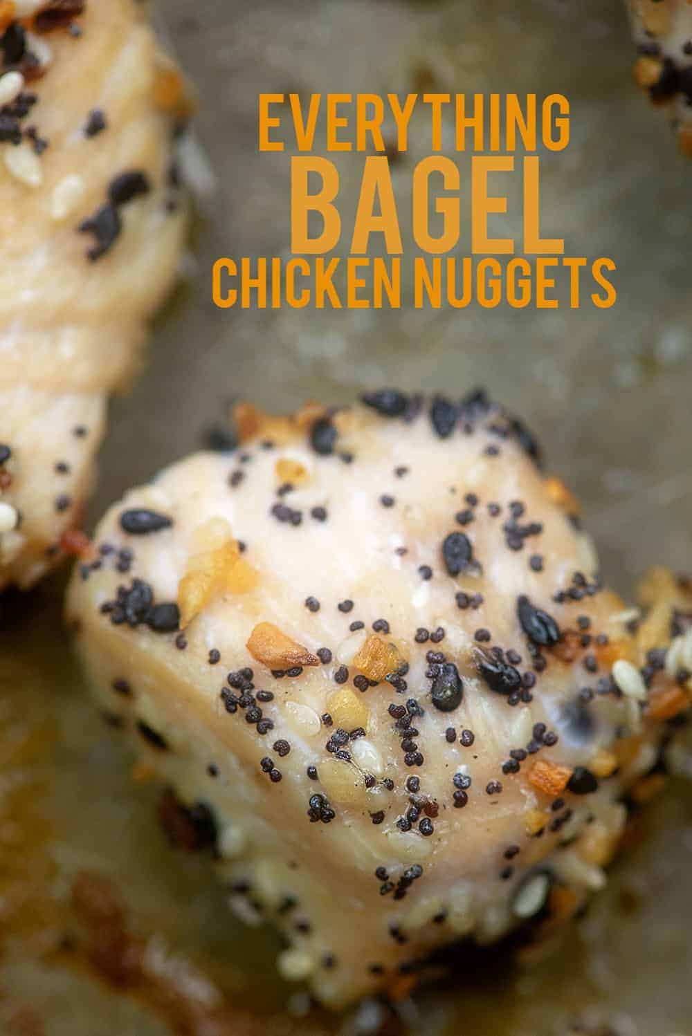 chicken nuggets coated in everything bagel seasoning on baking sheet.