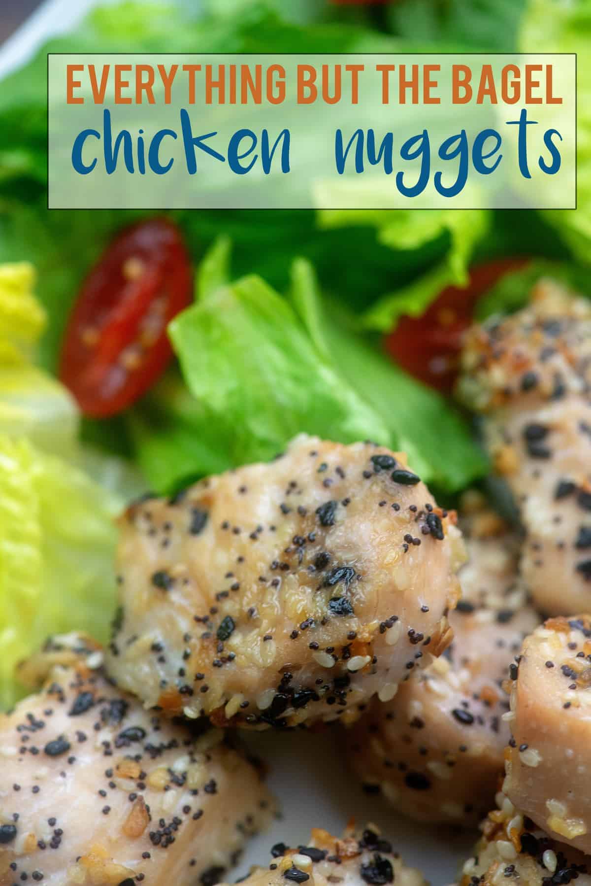 A close up of seasoned chicken nuggets in front of a salad.