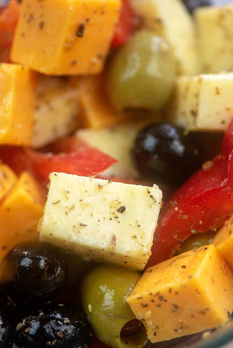 A close up of seasoned cheese and olives