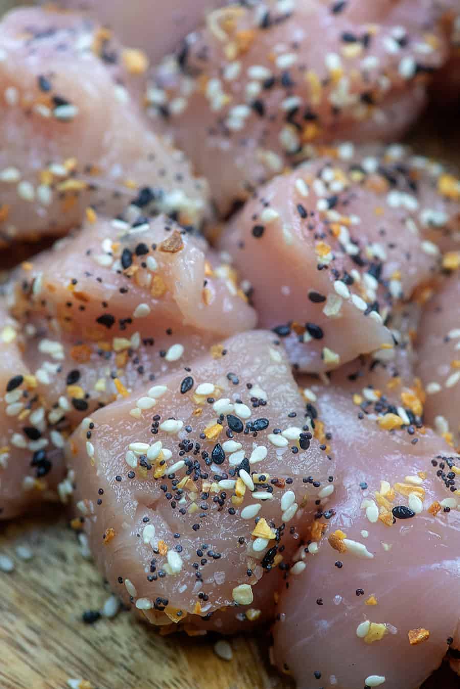 seasoned chicken bites on cutting board.