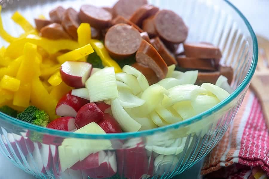 vegetables for sheet pan dinner in glass bowl.