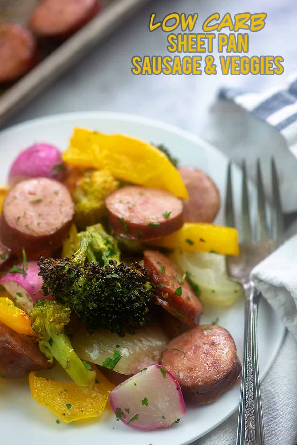 A plate of sausage and veggies with a fork on it.