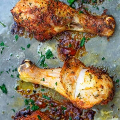 baked chicken legs on baking sheet