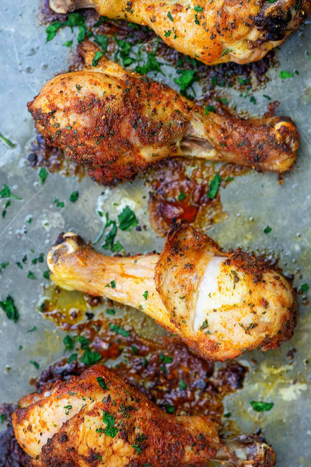 baked chicken legs on baking sheet