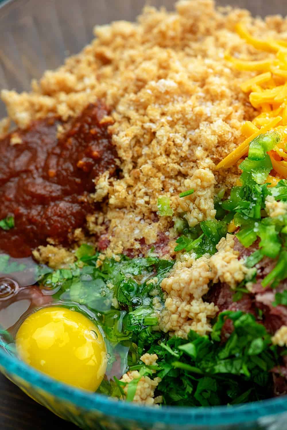 ingredients for low carb enchilada meatballs in glass bowl.