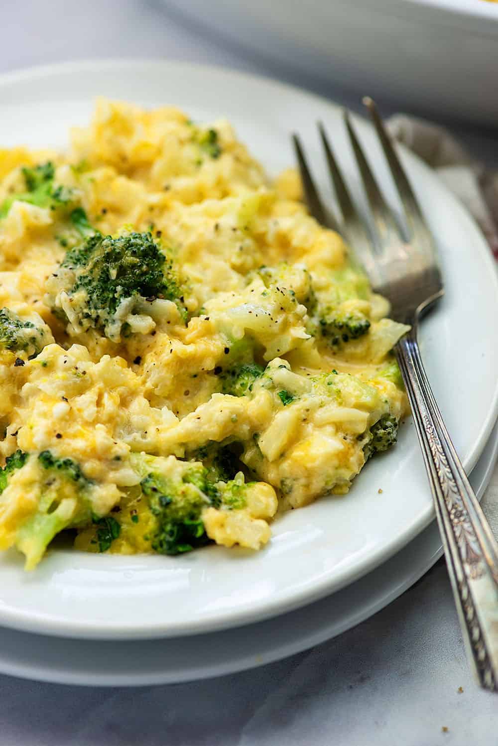 two white plates stacked with broccoli casserole