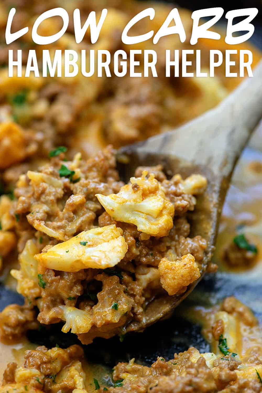 wooden spoon scooping hamburger helper out of a skillet