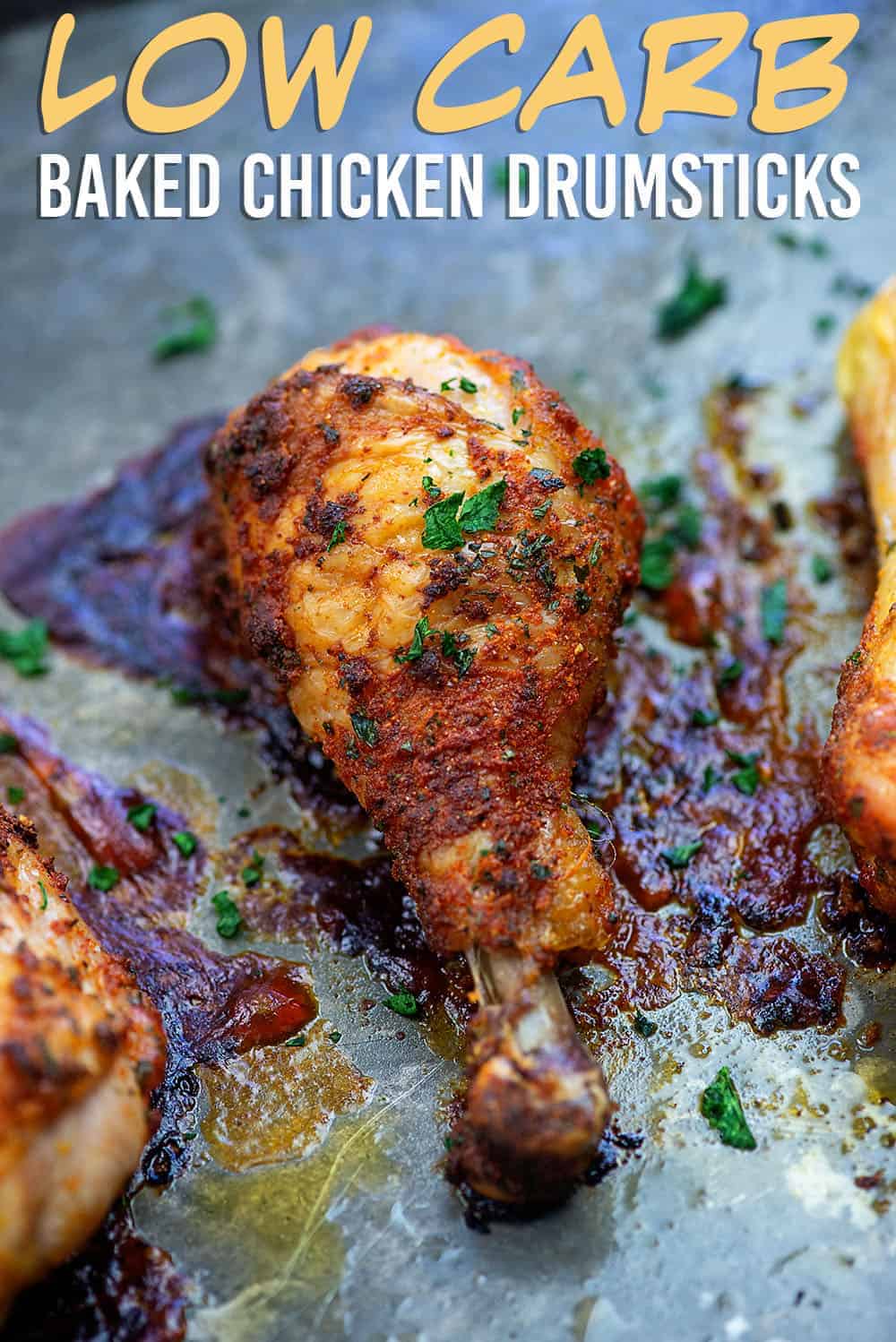 A close up of a chicken drumstick on a baking sheet.