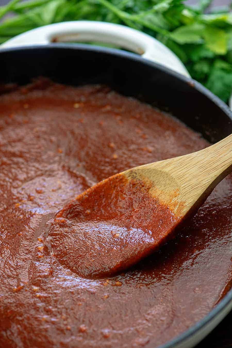 red sauce simmering in a white pot