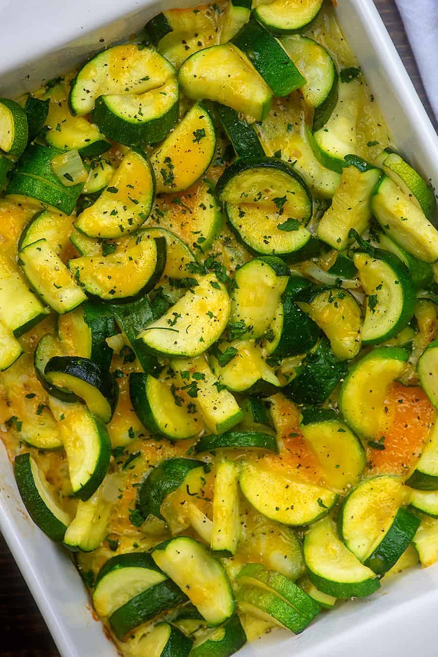 zucchini pieces in a white baking pan