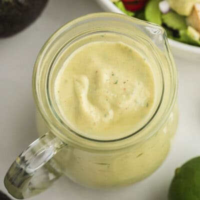 Avocado ranch salad dressing in small jar.