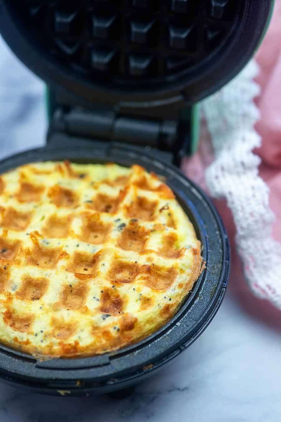 A chaffle being cooked in a mini waffle maker