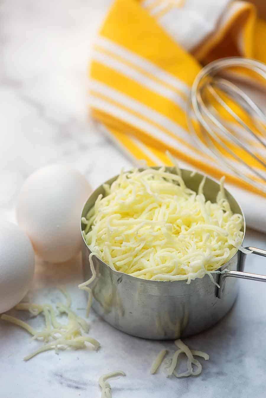 whole eggs and a cup of shredded cheese