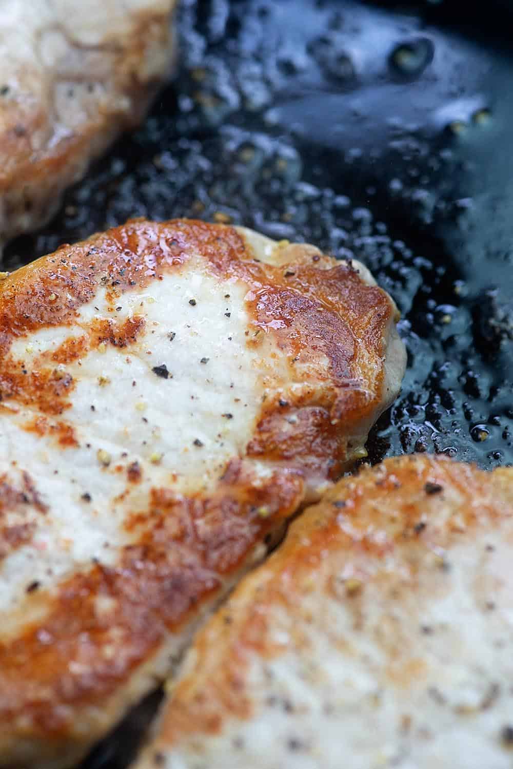 fried pork chops in skillet