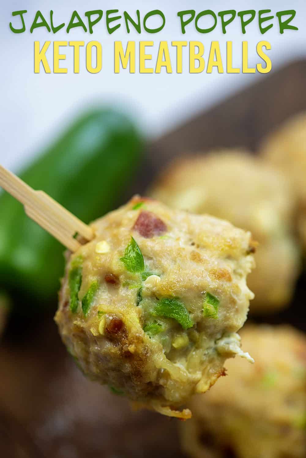 Holding a toothpick stabbed through a keto meatball